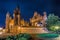 Vilnius church at night and yard with flowers