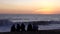 Vina del Mar, Chile - 2019-07-18 - Five Friends Sit on Beach Watching Sun Set In Front of Rough Surf