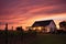 vineyard cottage, silhouetted against a twilight sky