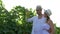 Vineyard, couple is harvesting crops with basket in hand and walking on field in sunlight