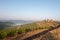 Vineyards with grapevine and winery along wine road in the evening, Tuscany, Italy