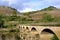 Vineyards on mountain slopes and ancient bridge