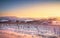 Vineyards rows covered by snow in winter at sunset. Chianti, Siena, Italy