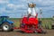 Vinnitsa/Ukraine - 04/19/2018: The forklift lifted Big bags of seeds above the drill to the tractor and the man evenly poured the