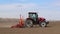 Vinnitsa, Ukraine - April 20, 2022: Spring sowing season. Farmer with a tractor sows corn seeds on his field. Planting corn with