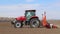 Vinnitsa, Ukraine - April 20, 2022: Spring sowing season. Farmer with a tractor sows corn seeds on his field. Planting corn with