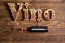 Vino lettering with bottle of wine on wood