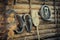 vintage accessories, old horse harness and household items on the background of a rough wooden log wall