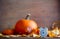 Vintage alarm clock and maple tree leaves with pumpkins