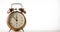 Vintage alarm clock with spinning hand on clock face on white background.
