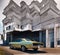 Vintage American muscle car in front of a historic building.