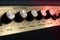 Vintage amplifier five knobs diagonal closeup, magenta