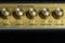 Vintage amplifier five knobs horizontal closeup, music recording studio equipment, bottom copy space