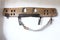 Vintage animal ox wooden harness with a leather belt strap on a white stable wall