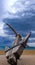 Vintage, antic anchor on the promenade on cloudy sky background