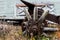 Vintage antique automotive tractor broken wood wheel spokes and hub covered in rust