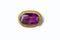 Vintage antique brooch with a large semi-precious purple stone on white background. Oldfashioned decoration from grandma`s jewelr