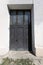 Vintage antique front door. Vintage architectural background of building entrance. Fragment background element of an ancient