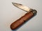 vintage antique military pocket knife with used and rusty blade white background