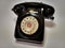 A vintage and antique telephone with white background.