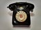 A vintage and antique telephone with white background.