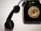 A vintage and antique telephone with white background.