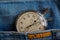 Vintage antiques Stopwatch, in old worn dark blue jeans with orange stripe pocket, value measure time, old clock arrow minute, sec