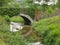 Vintage arch bridge over a stream small stream