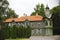 Vintage architecture green wooden house with red tiled roof top with pine trees