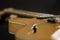 Vintage archtop guitar in natural maple close-up high angle view on black background, pick-up side in selective focus