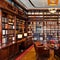 A vintage, Art Deco library with rich mahogany bookshelves, leather armchairs, and a rolling ladder4, Generative AI