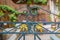 Vintage artistic green wrought iron gate with peeling paint and rust revealing blurred garden