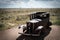 Vintage automobile parked on a desolate desert landscape