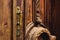 Vintage background. Brass-made old handle with Elements of an carved wooden door decorated with massive wooden