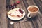 Vintage background. Slice of homemade cherry pie and cup of coffee with fresh cherries on wooden rustic background. Selective