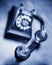 Vintage bakelite dial telephone on rustic metal surface. Selective focus