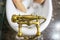 Vintage bath taps, golden tap with against the backdrop of a bath filled with water and white foam and the legs of a relaxed perso