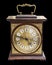 Vintage beautiful clock with a wooden case and gold jewelry isolated on black