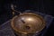 Vintage Beautiful faucet and golden mixer tap on a marble round sink in the bathroom. Interior of an expensive toilet