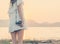 Vintage of beautiful women photography standing hand holding retro camera with sunrise,dream soft style