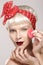 Vintage beauty model applying powder on skin closeup