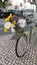 Vintage bicycle with a bouquet of daisies and sunflowers and a straw basket.