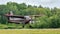 Vintage biplane landing above runway