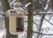 Vintage bird feeders. Handmade. Bird feeder covered with snow. Small depth of field.