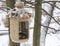 Vintage bird feeders. Handmade. Bird feeder covered with snow. Small depth of field.