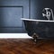 Vintage black bathtub with silver legs in antique interior with