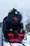Vintage black steam locomotive train rush railway. winter
