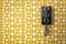 Vintage black wall mounted telephone on mid-century modern wall paper