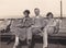 Vintage black and white photo of a family at the seaside. 1950s