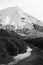 Vintage black and white photo of a gravel trail heading towards magnificent snow covered cone of Mt Taranaki.